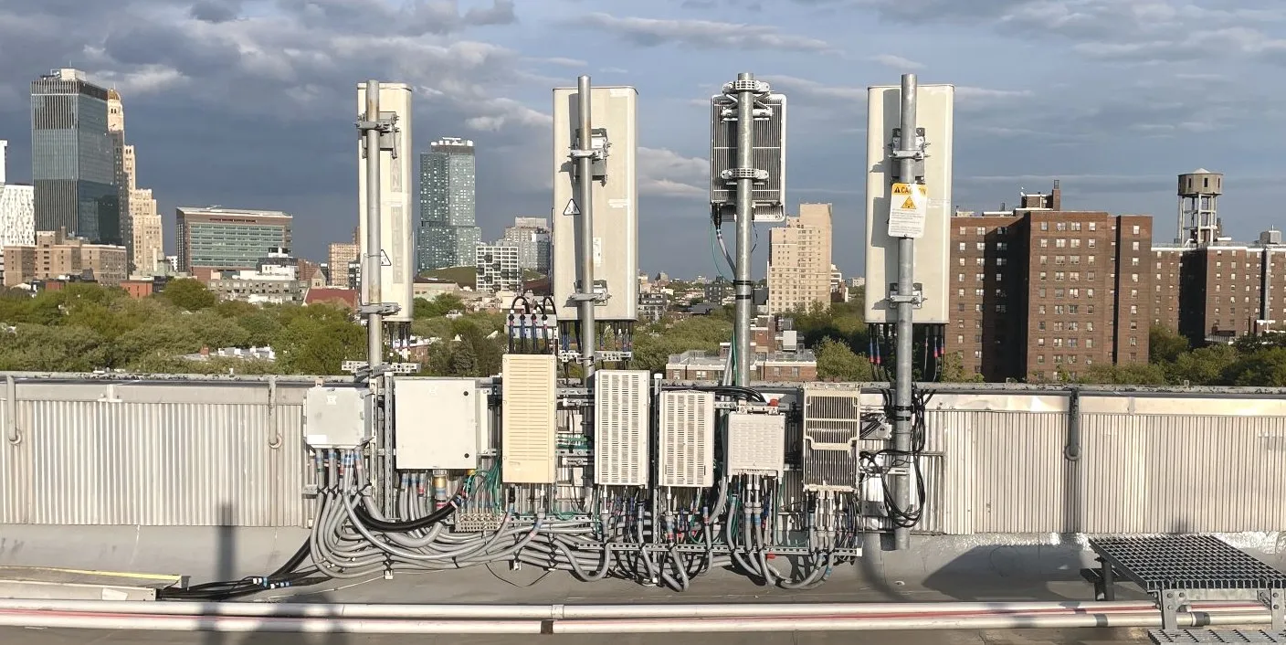 Rooftop cell site with antennas over a city skyline