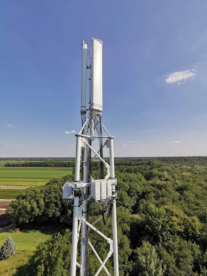 Telecoms tower overlooking green farmland